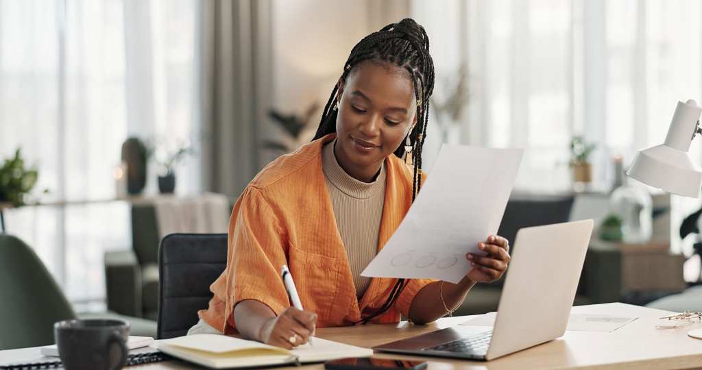 Woman reviewing occupational health documents at desk.