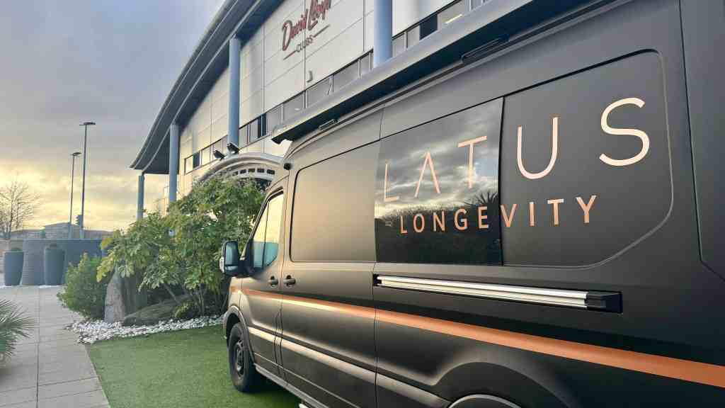 LATUS Group van promoting longevity solutions outside a modern building.