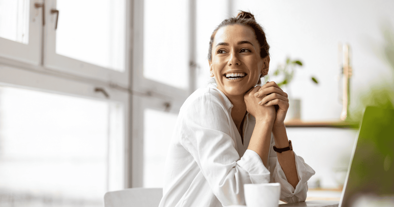 Professional woman smiling in modern office environment.