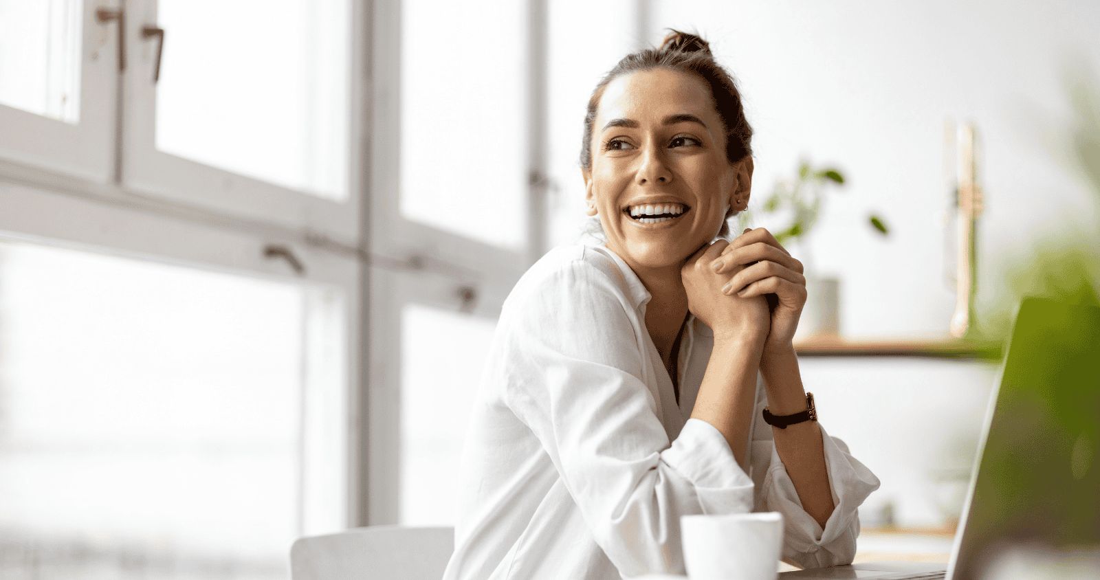 Professional woman smiling in modern office environment.