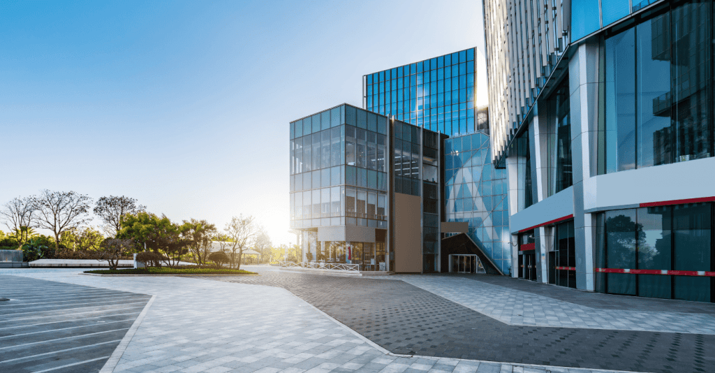 Modern office building exterior with glass facades and urban surroundings.