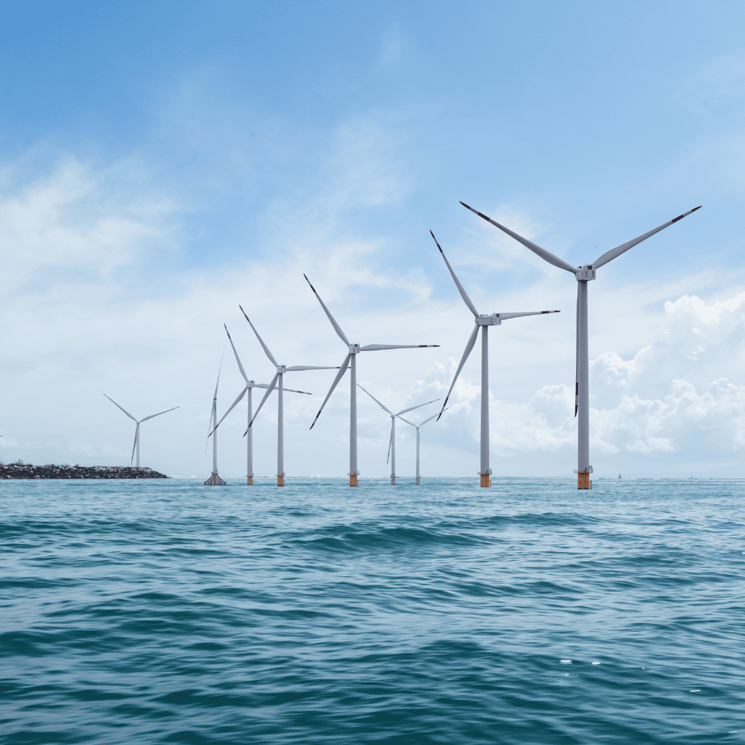 Offshore wind turbines in the sea with safety protocols for workers on site.