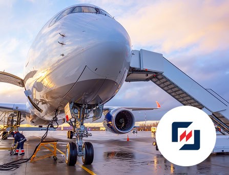 Aircraft at airport gate with jet bridge, ready for boarding or departure.