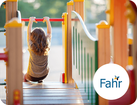 Child playing on a playground climbing frame.
