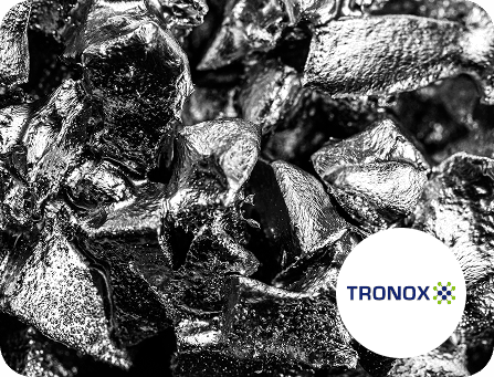 Black coal pieces with Tronox logo, industrial material focus.